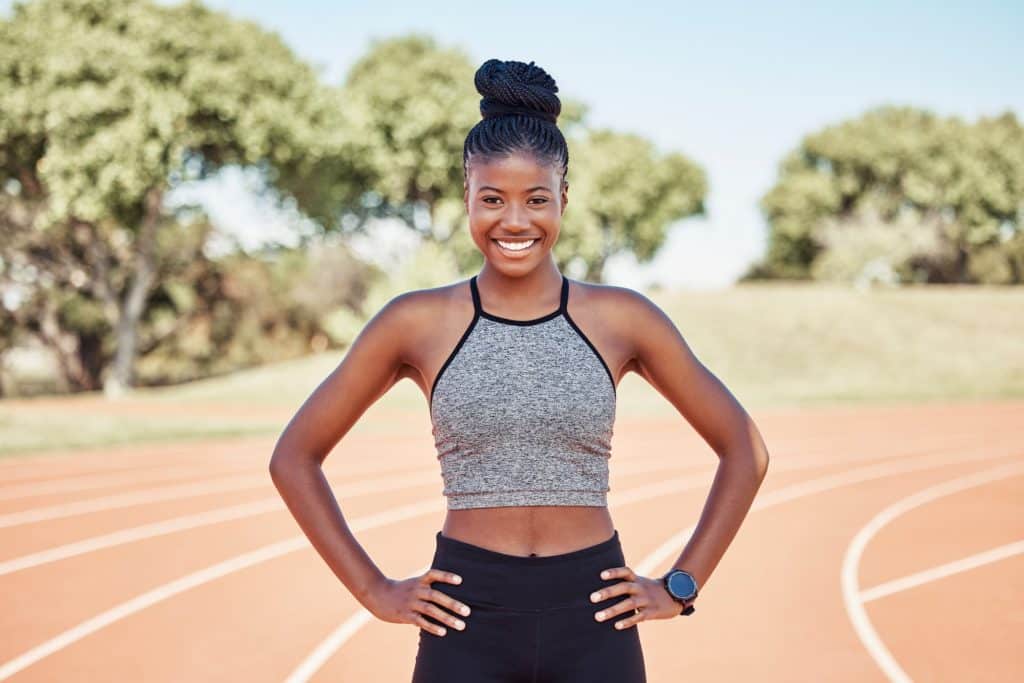 Portrait, black woman and athlete with smile, outdoor and health for wellness, workout and happy on