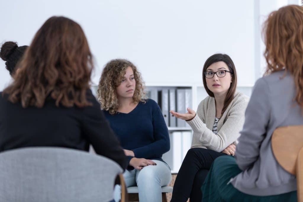 Women with problems sitting together during counseling