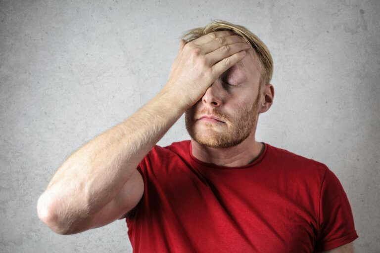 Image of male experiencing anxiety with hand on his head