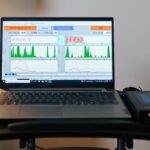 IASIS Microcurrent Neurofeedback equipment displaying brainwave activity during a neurofeedback therapy session. The system is used to help improve mental health conditions such as anxiety, PTSD, and brain fog by calming the nervous system and promoting brainwave regulation."