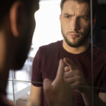 side-view-anxious-man-looking-mirror