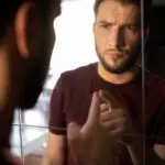 side-view-anxious-man-looking-mirror