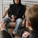 Teen receiving trauma therapy support during a counseling session