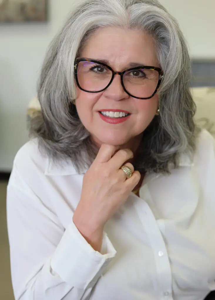 Eileen Borski, Licensed Professional Counselor and Certified EMDR Therapist at Authentic Brain Solutions in Conroe, Texas, smiling in a white blouse and glasses.