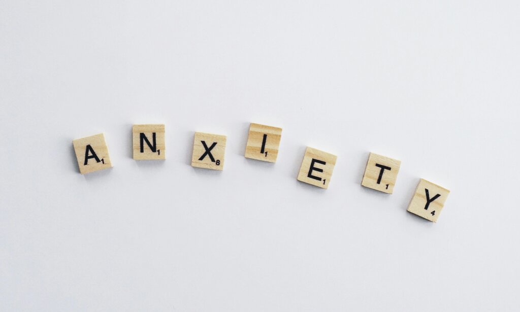 “Scrabble tiles spelling the word anxiety on a white background, symbolizing how high-functioning anxiety can be hidden in plain sight.”
