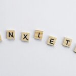 “Scrabble tiles spelling the word anxiety on a white background, symbolizing how high-functioning anxiety can be hidden in plain sight.”