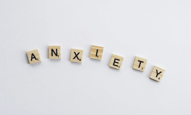“Scrabble tiles spelling the word anxiety on a white background, symbolizing how high-functioning anxiety can be hidden in plain sight.”
