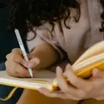 Woman journaling to reduce rumination and overthinking as part of depression therapy in Conroe, TX.