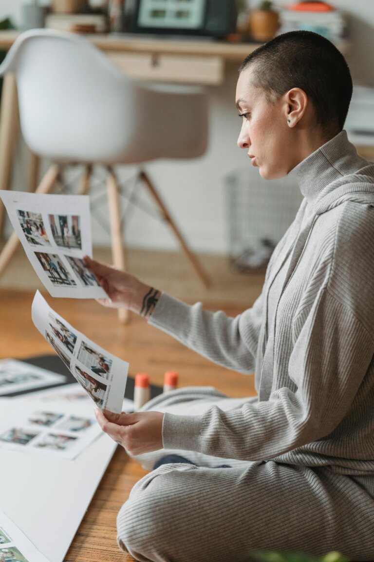 Person experiencing reduced productivity while reviewing work materials, reflecting mental fatigue, burnout, and the need for compassion and nervous system regulation