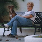 Person sitting quietly on a bench with a dog reflecting during depression recovery and emotional healing through brain-based therapies