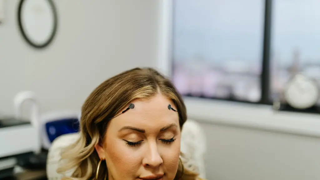 Woman in neurofeedback session with sensors on forehead at Authentic Brain Solutions in Conroe TX