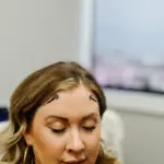 Woman in neurofeedback session with sensors on forehead at Authentic Brain Solutions in Conroe TX