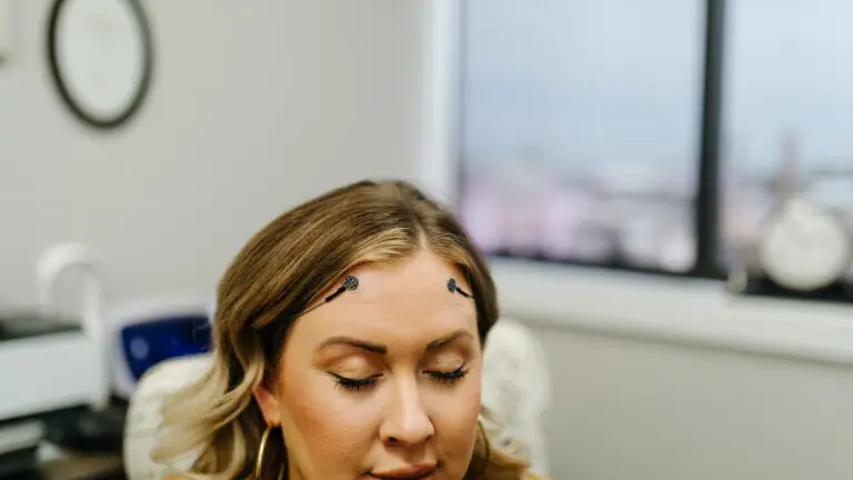 Woman in neurofeedback session with sensors on forehead at Authentic Brain Solutions in Conroe TX
