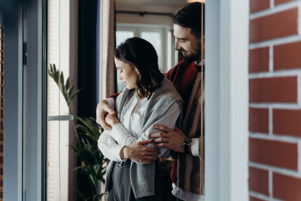 a-man-holding-a-woman-from-behind