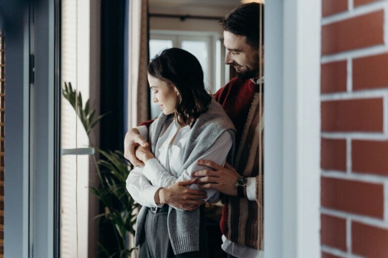 a-man-holding-a-woman-from-behind